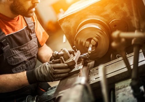 Turner is working on the machine.metal processing.worker works on a lathe.Turner running on the machine. Turning work. metal processing.