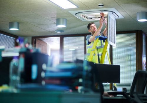 air con maintenance engineer in empty office floor