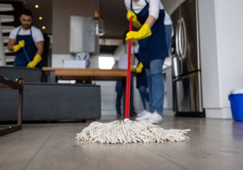 Close-up on a professional cleaner mopping the floor - housework concepts